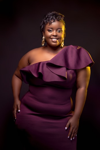 a woman in a purple dress posing for a picture