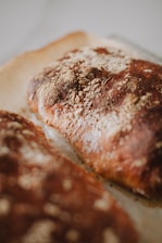 Close-up of freshly baked gluten-free bread with a golden crust on a wooden table.