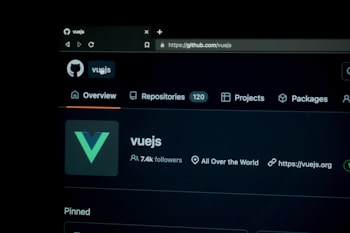 A screenshot of the Vue.js repository on GitHub is displayed, showcasing the repository overview with navigation options like Overview, Repositories, Projects, and Packages. The Vue.js logo is visible alongside details such as the number of followers and links related to the project.