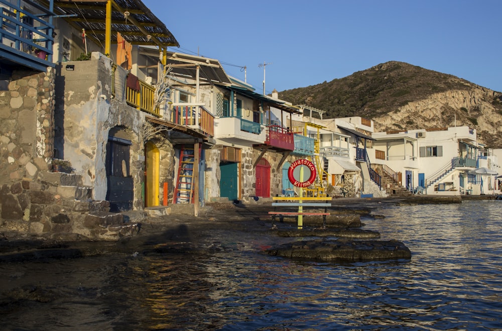 a body of water next to a row of buildings