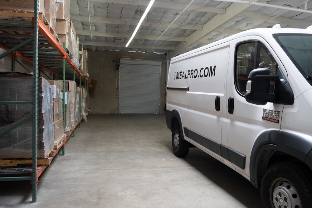a white van parked inside of a warehouse