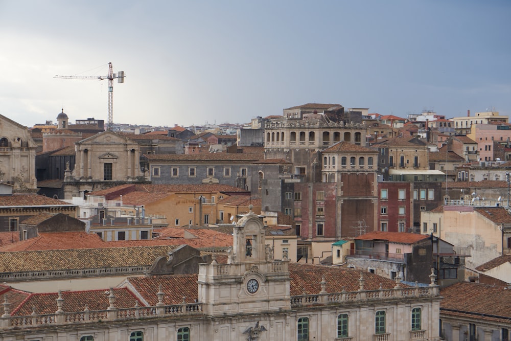 a view of a city with old buildings and a crane in the background