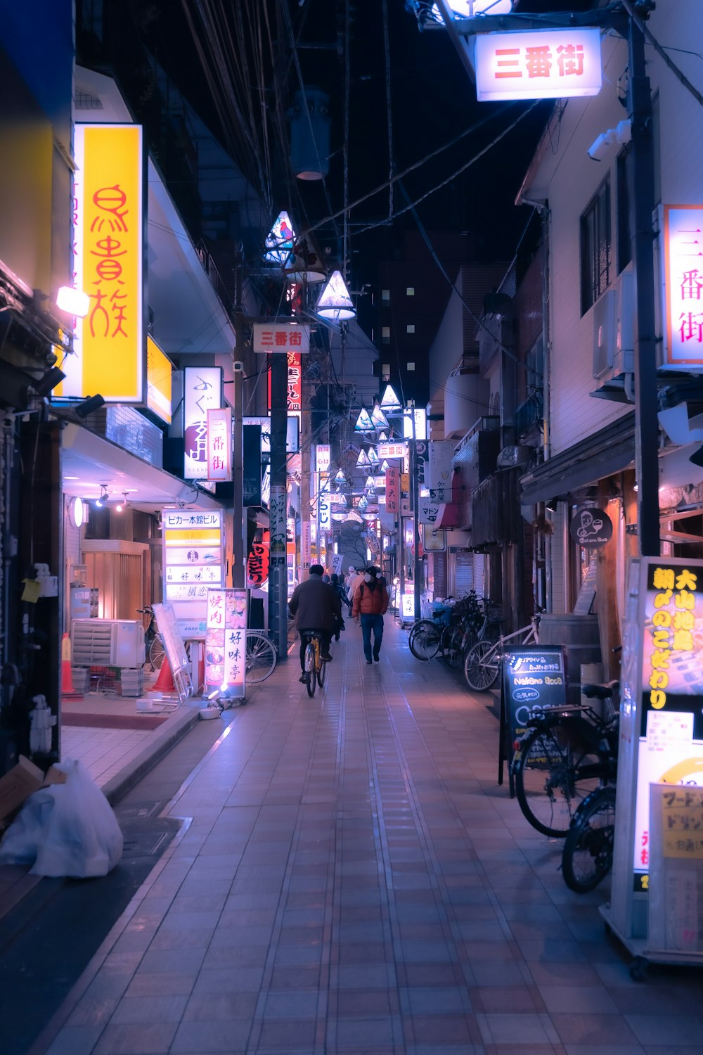 a couple of people that are walking down a street