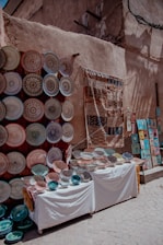 A vibrant display of handmade pottery and woven textiles.