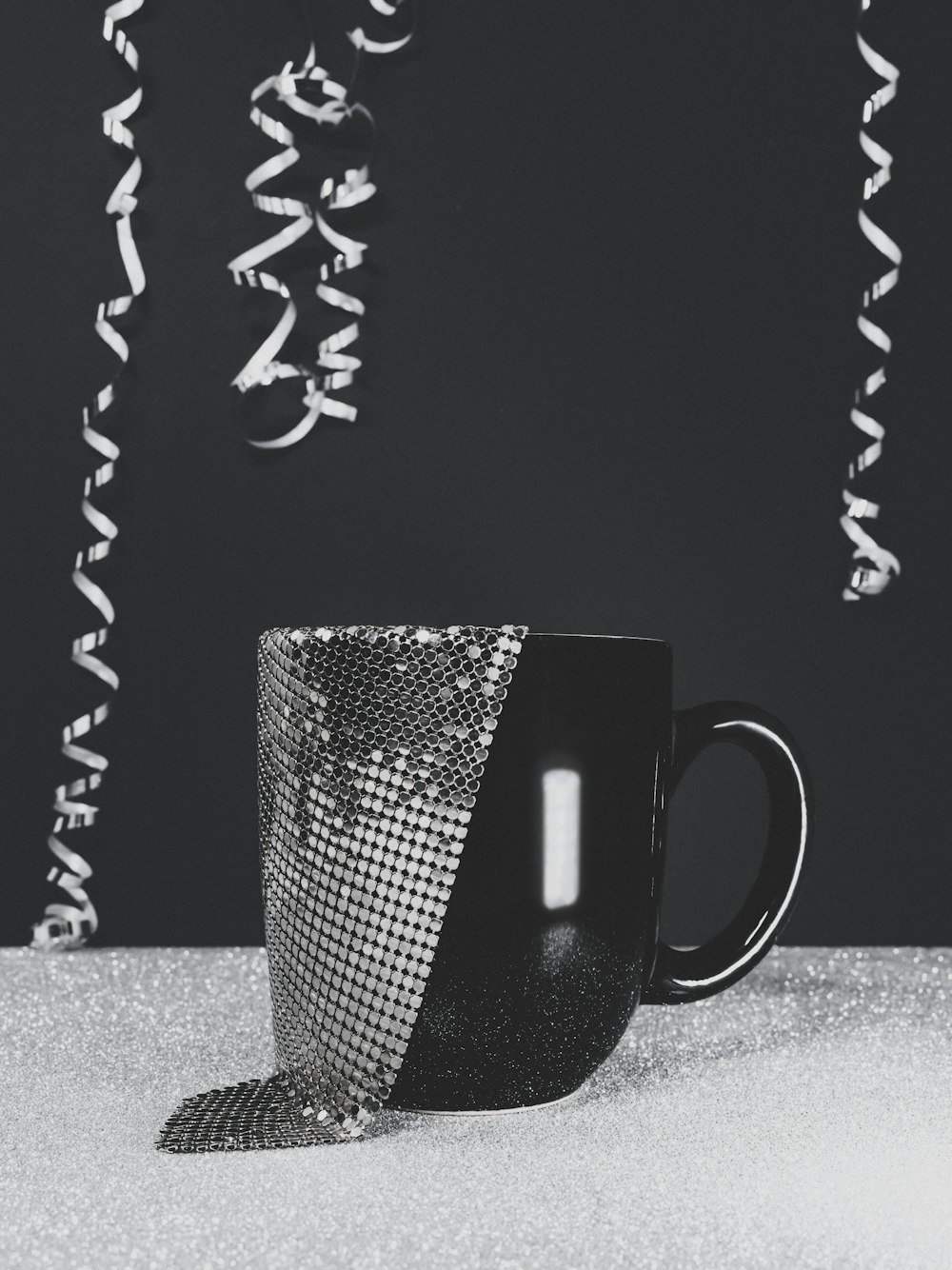 a black and white photo of a coffee cup