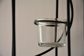Close-up of a plastic container being molded by advanced machinery.