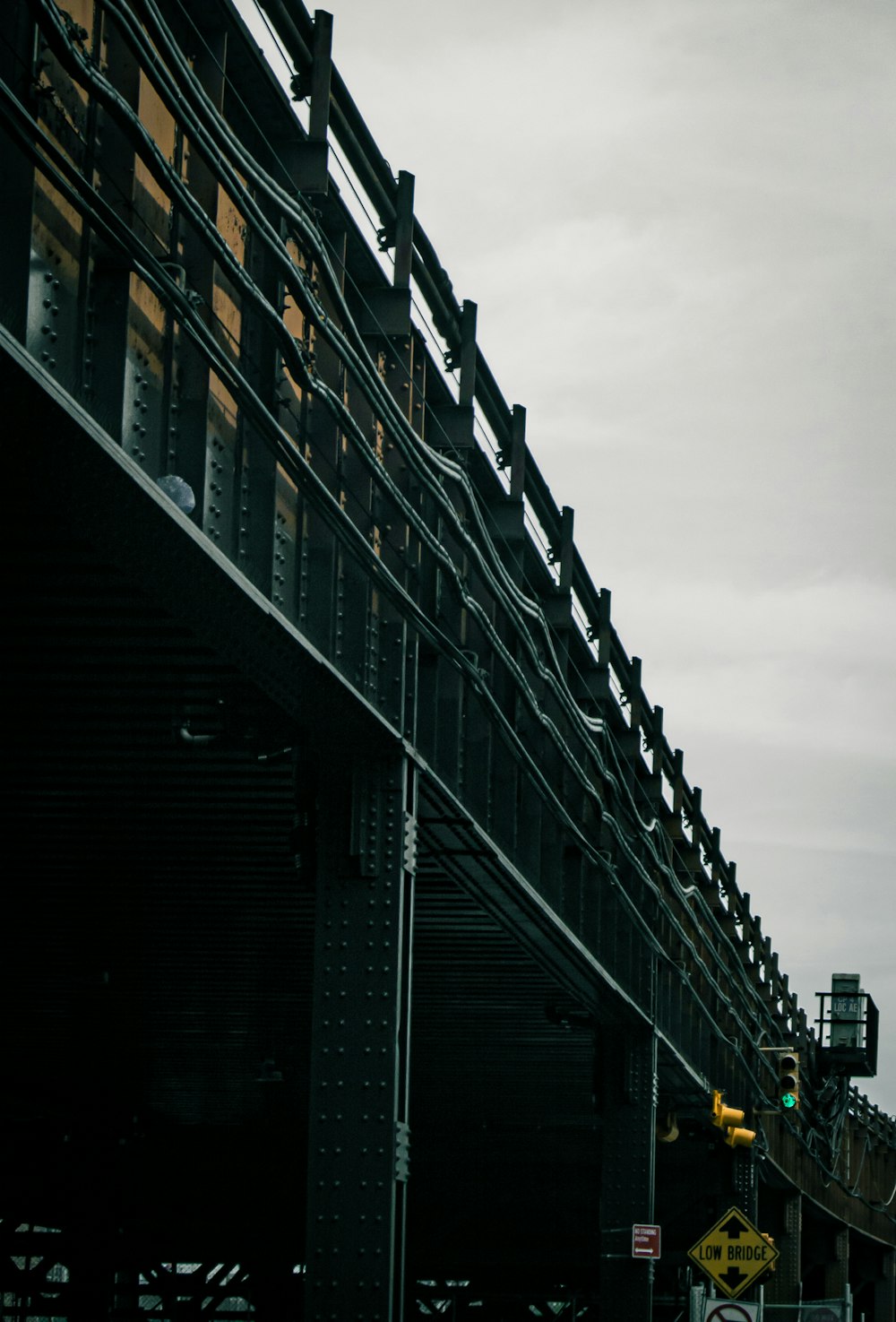 a traffic light hanging over a street next to a tall building