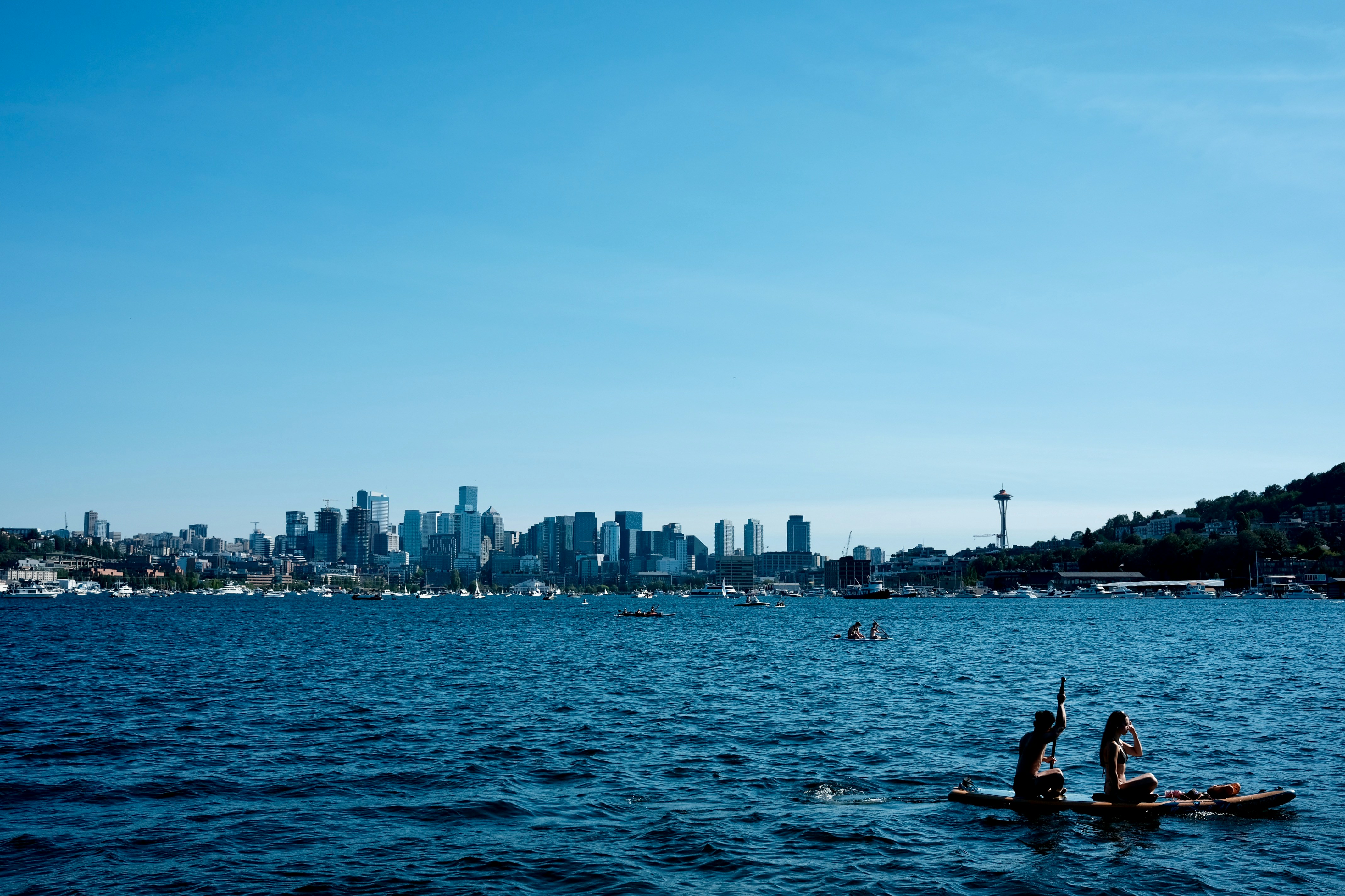 a couple of people on a paddle boat in the water