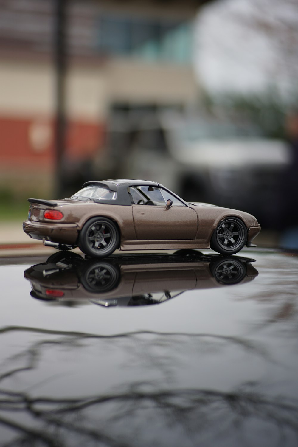 a toy car sitting on top of a shiny surface