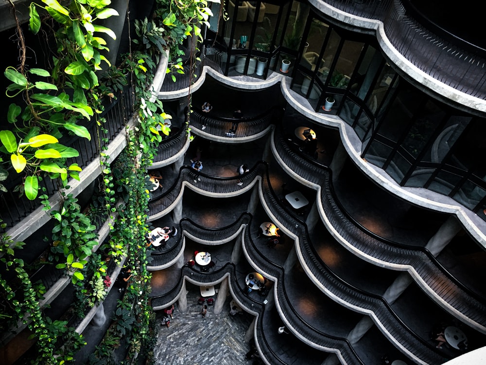 a very tall building with lots of plants growing on it