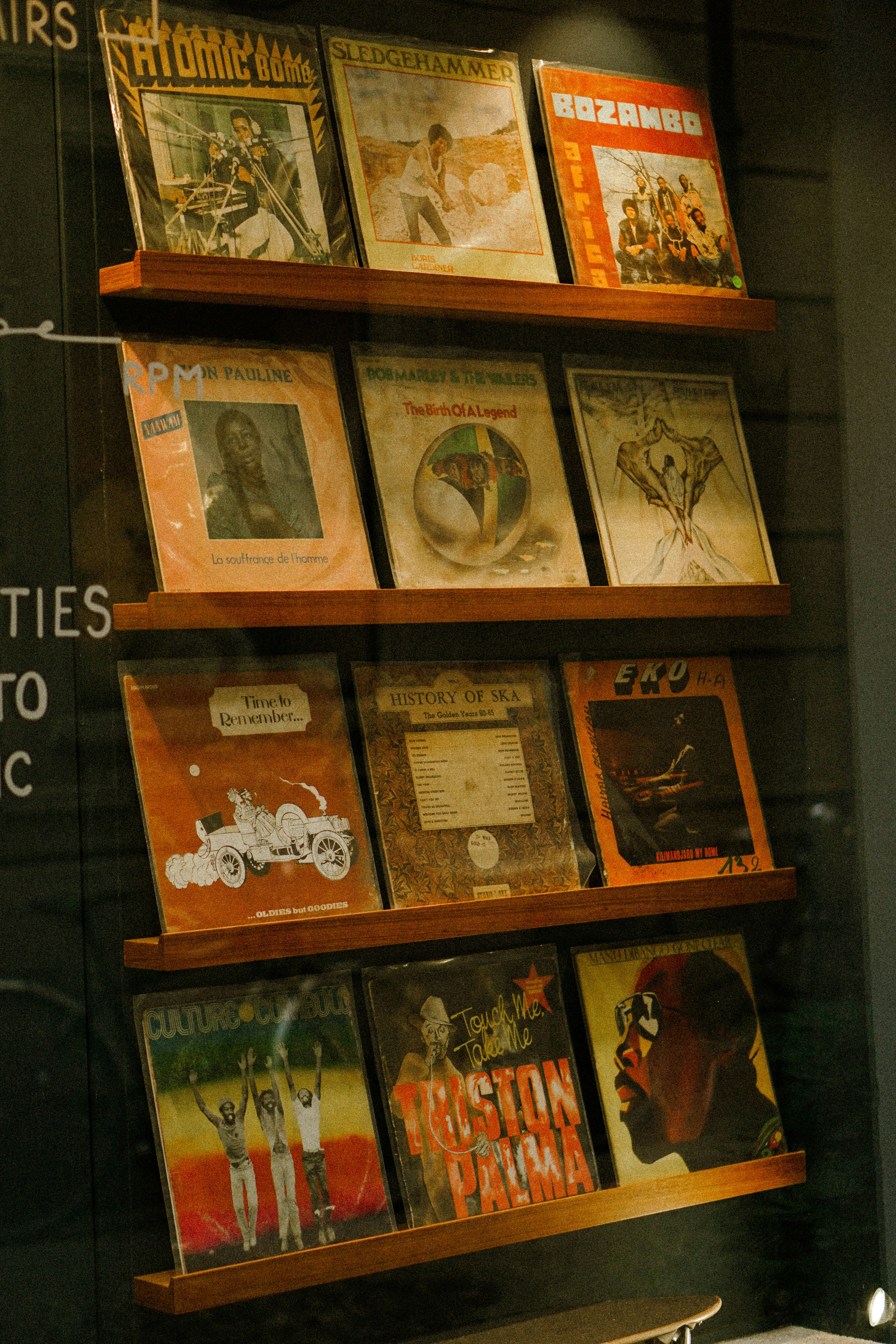 A display of various records in a store window photo – Free Woman Image ...