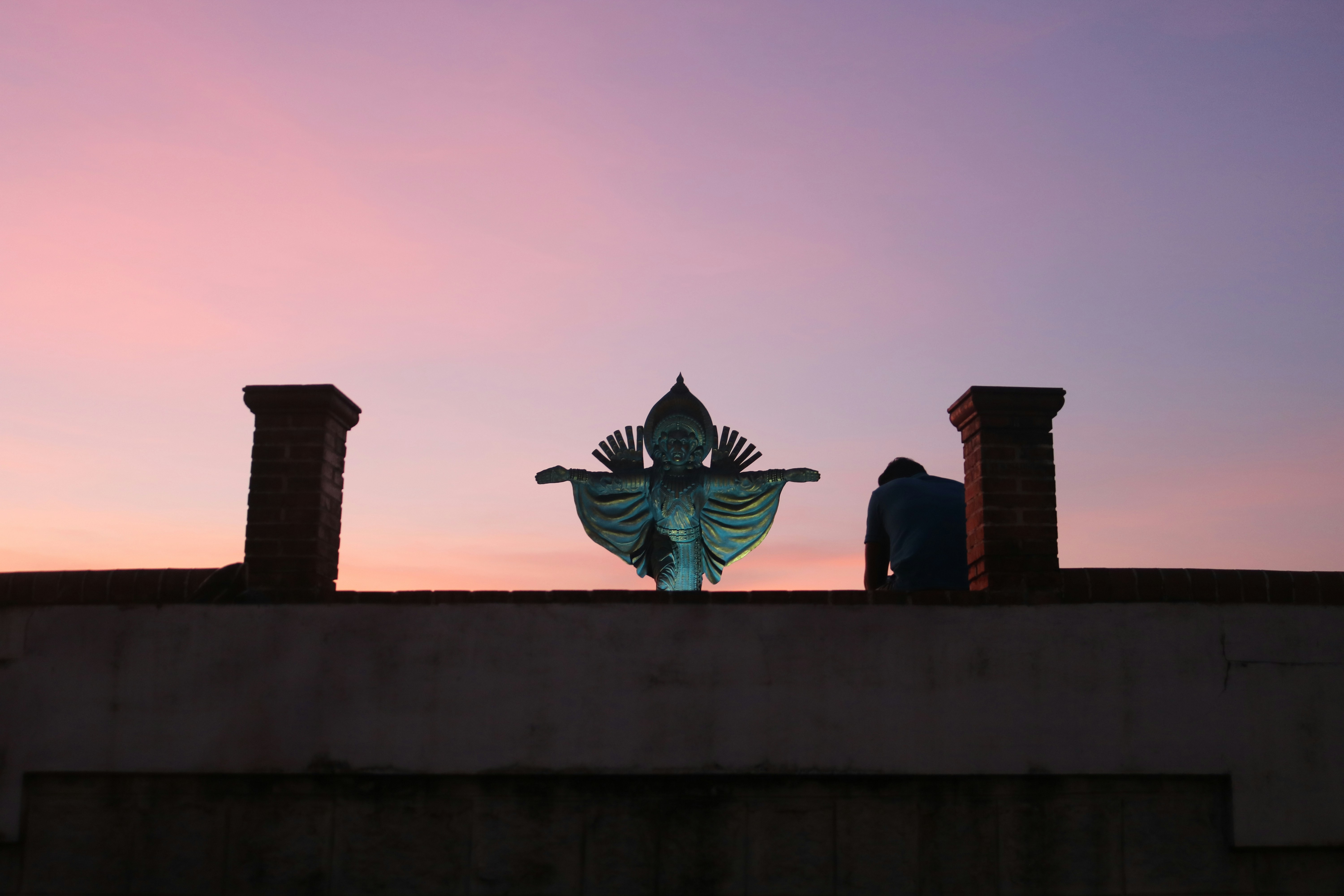 a couple of people standing on top of a roof