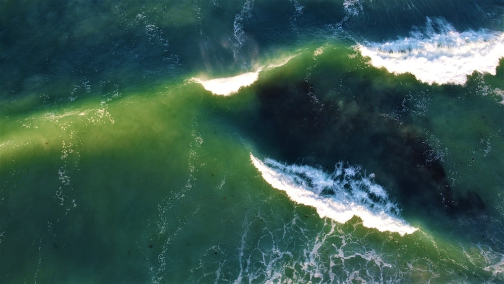 an aerial view of the ocean with waves