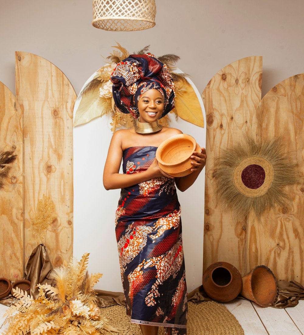 a woman in a colorful dress holding a plate