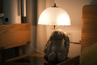 A cozy nursery corner with soft toys and a glowing nightlight casting a warm ambiance.