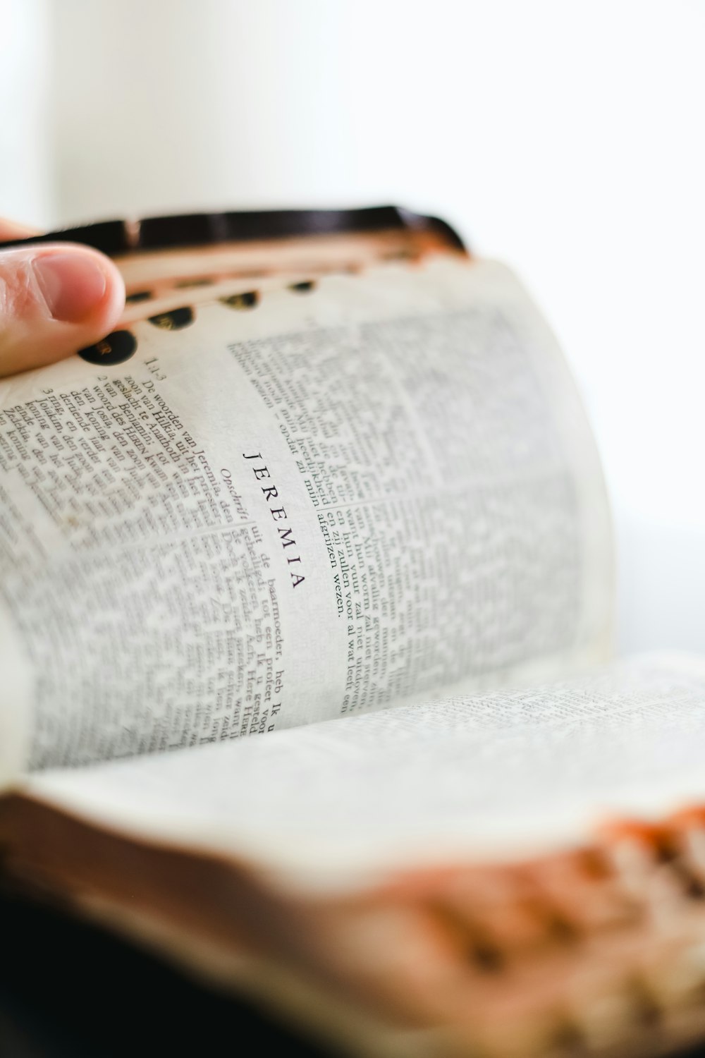 a close up of a person holding an open book