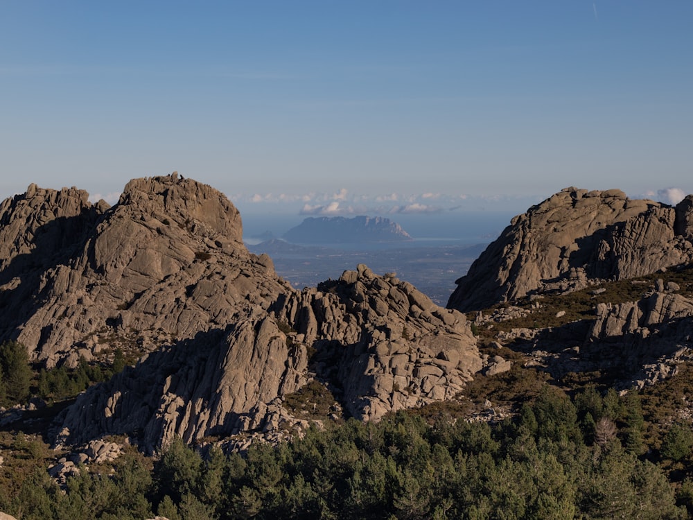 a mountain range with trees and mountains in the background