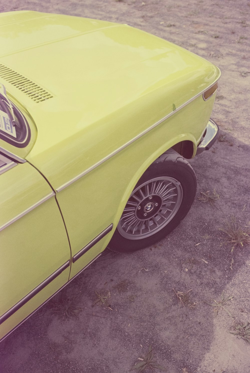 a yellow car parked in a parking lot