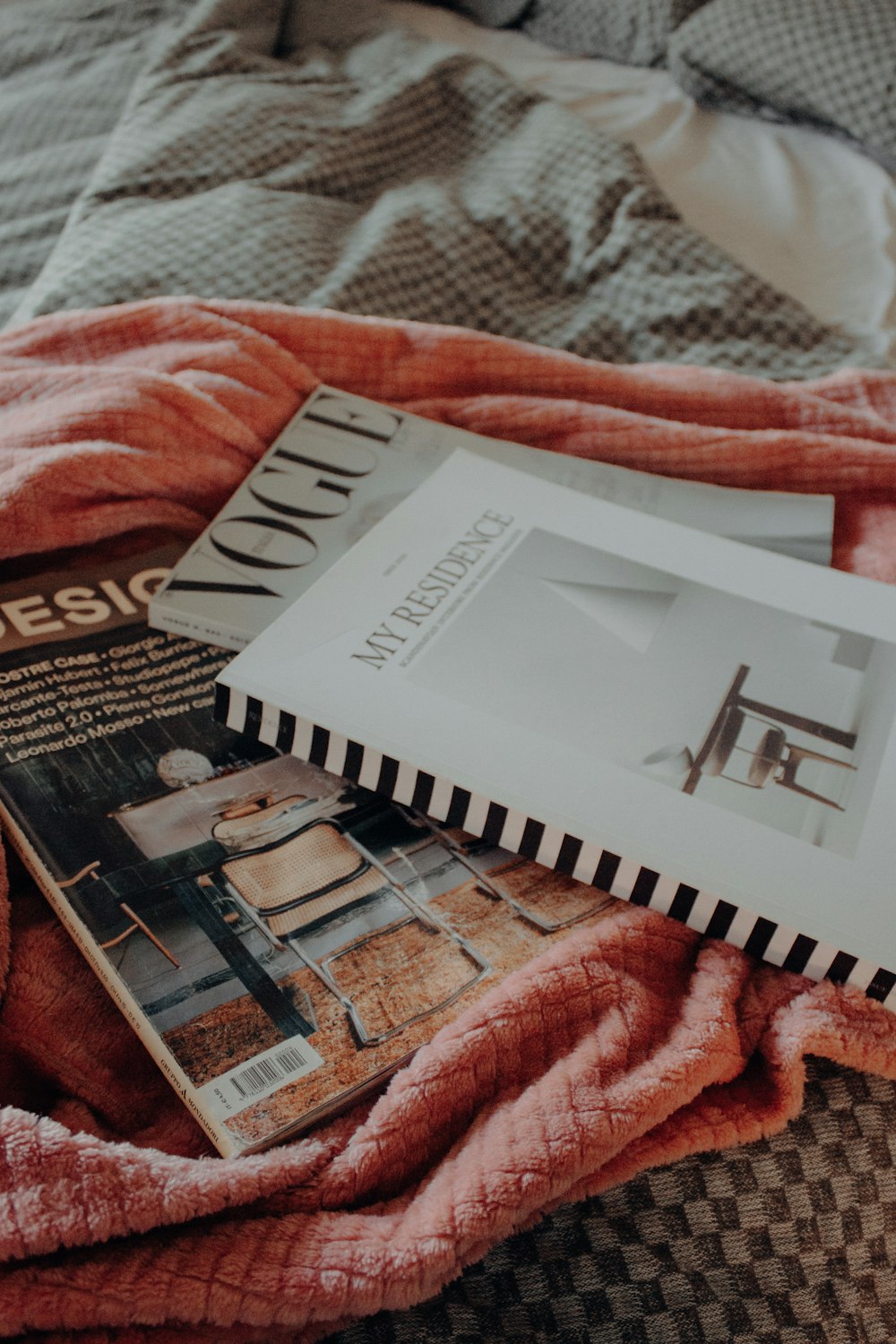 a bed with a blanket and a book on top of it