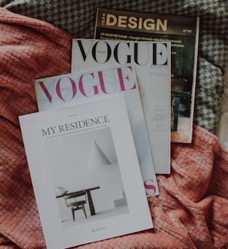 a couple of magazines laying on top of a bed