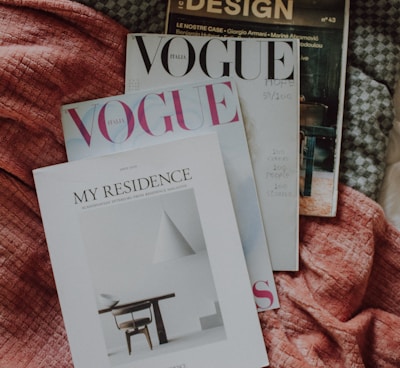 a couple of magazines laying on top of a bed