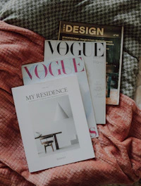 a couple of magazines laying on top of a bed