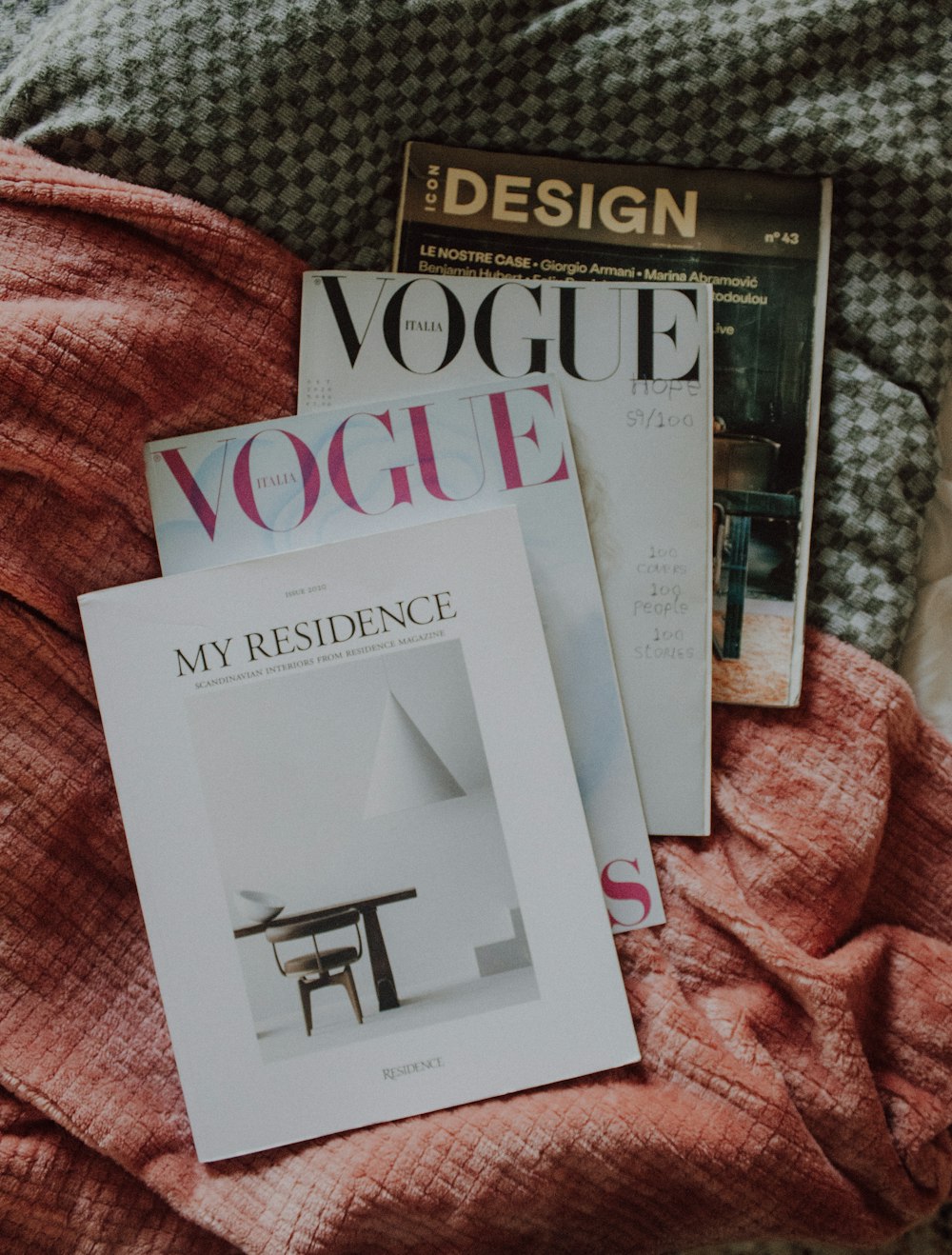 a couple of magazines laying on top of a bed