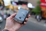 a person holding a smart phone in their hand