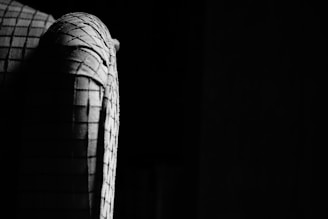 Close-up of rugged golf apparel fabric with subtle texture under strong lighting.