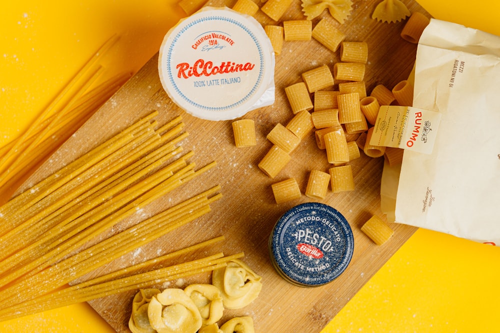 a cutting board topped with pasta and cheese