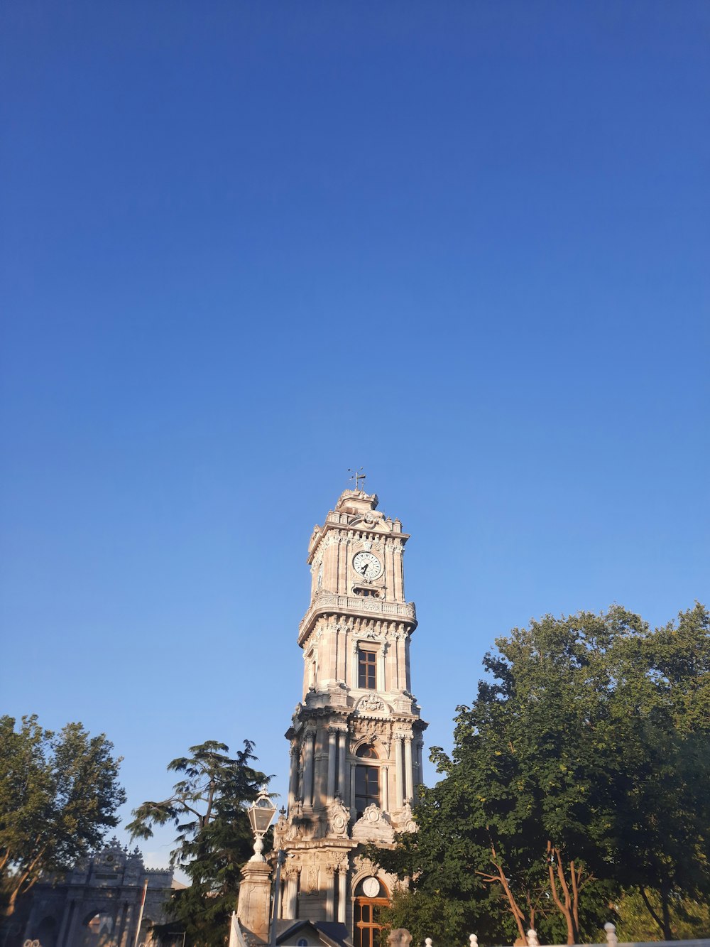 a tall clock tower with a clock on each of it's sides