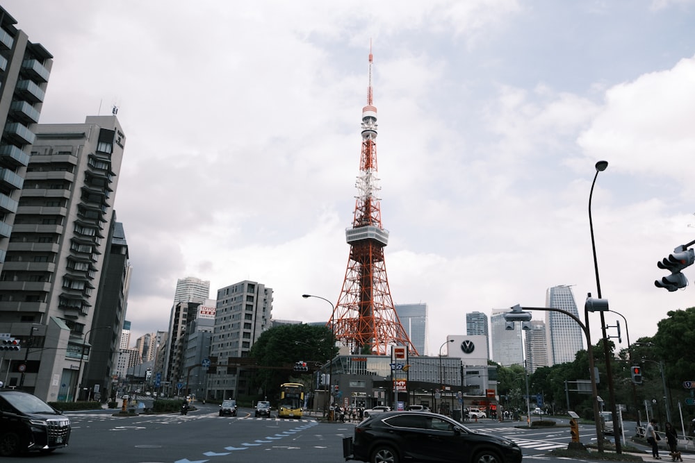 a car driving down a street in front of a tall tower