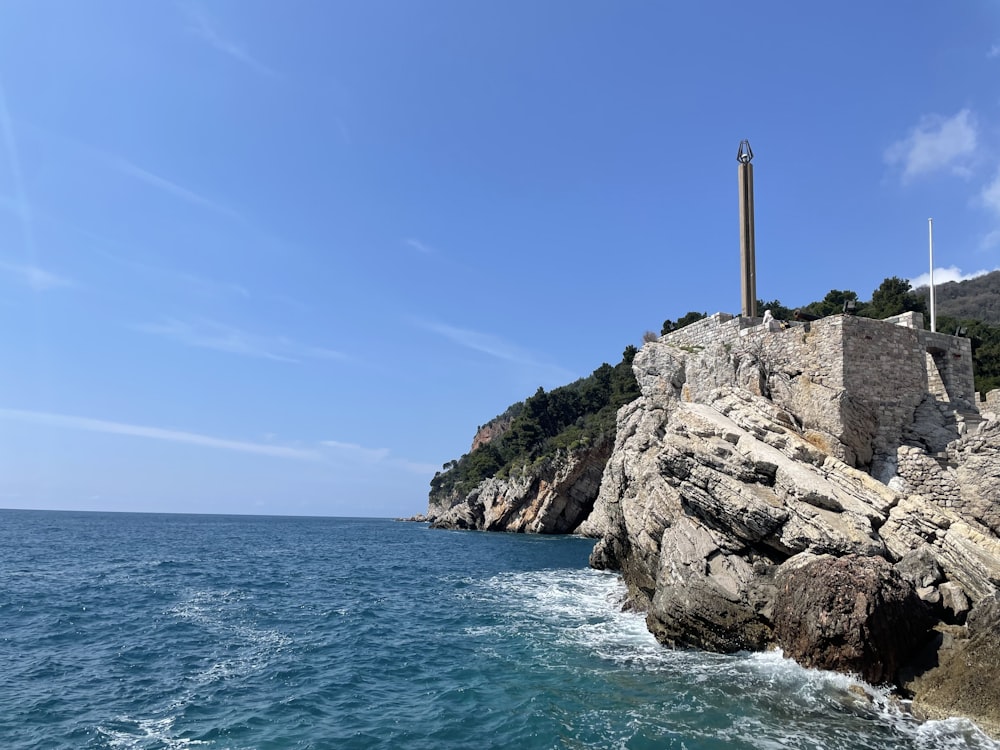 a lighthouse on top of a rocky outcropping