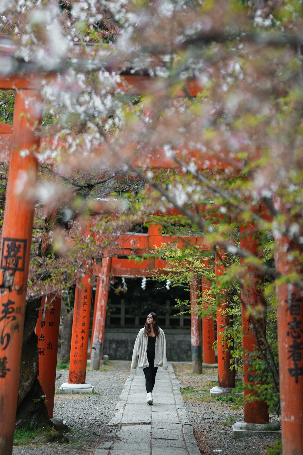 a woman walking down a path in a park