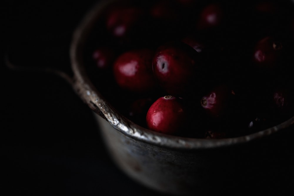 a close up of a bowl of cherries on a table