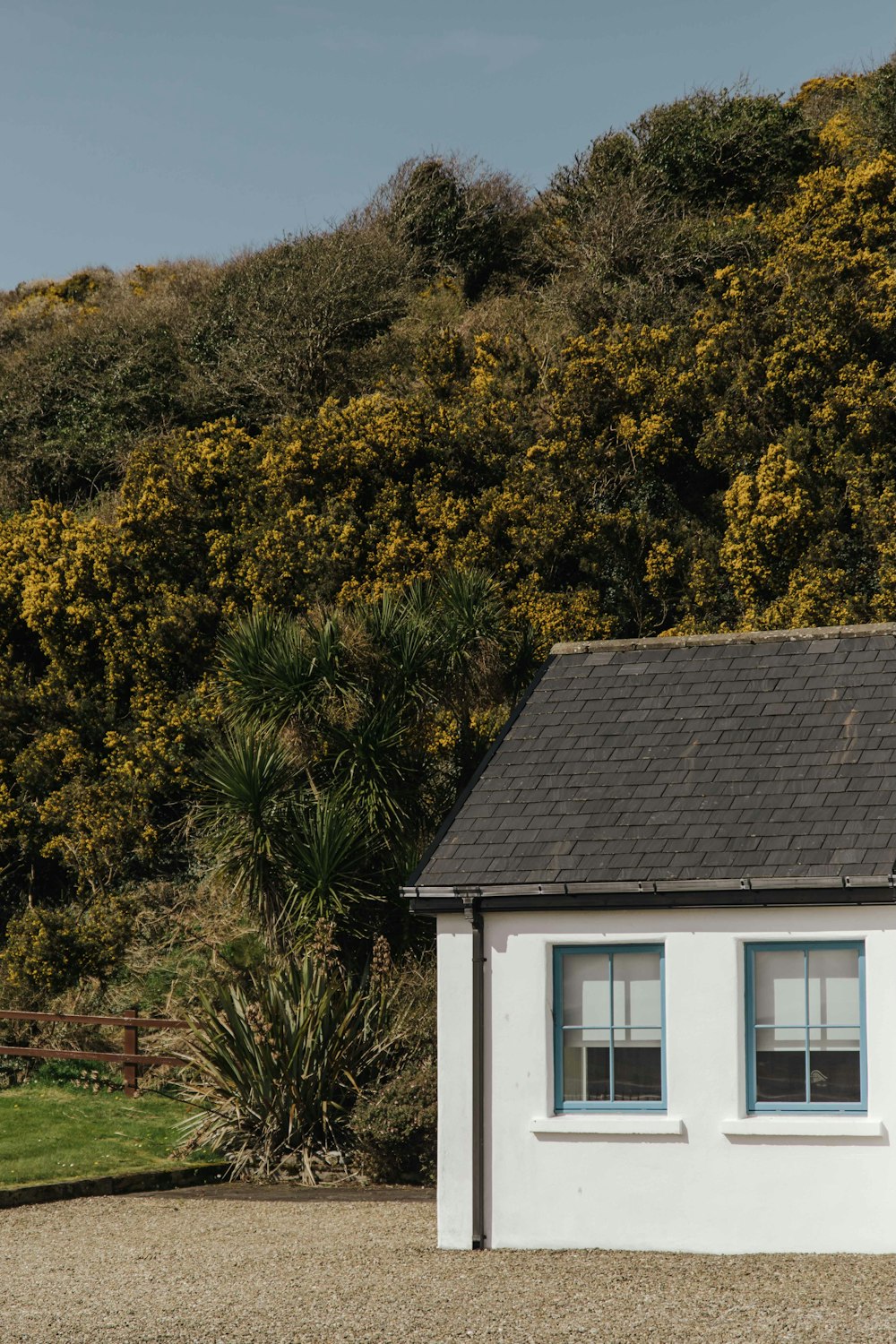 a small white house with a black roof