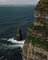 a large rock formation in the middle of a body of water