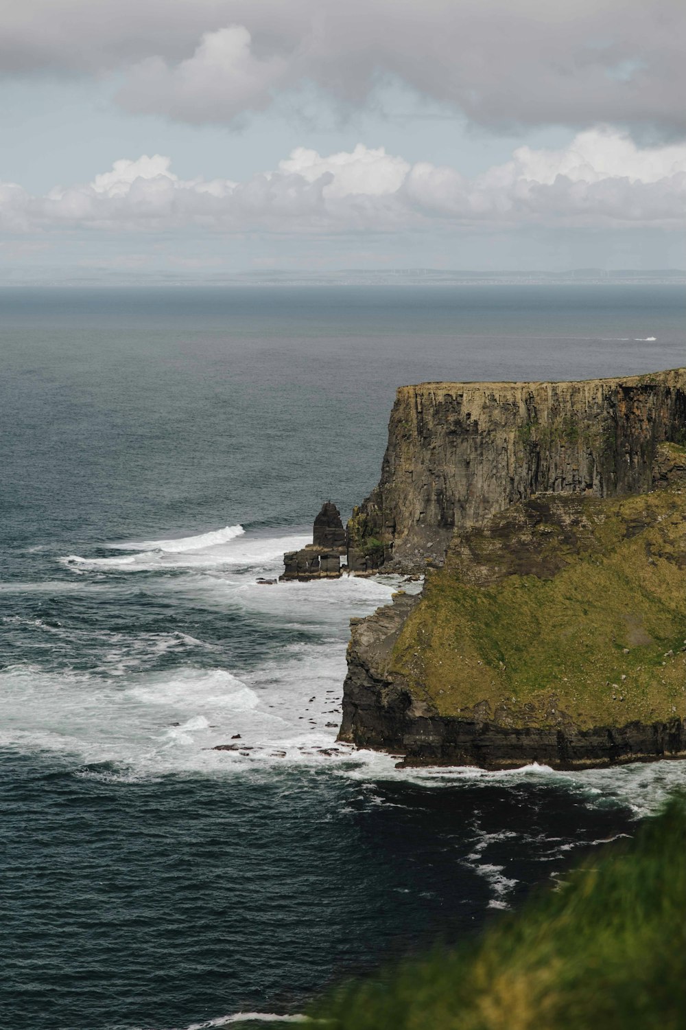 a large body of water next to a cliff