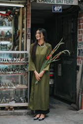 A happy customer holding a Vitalora package outside the New York store.