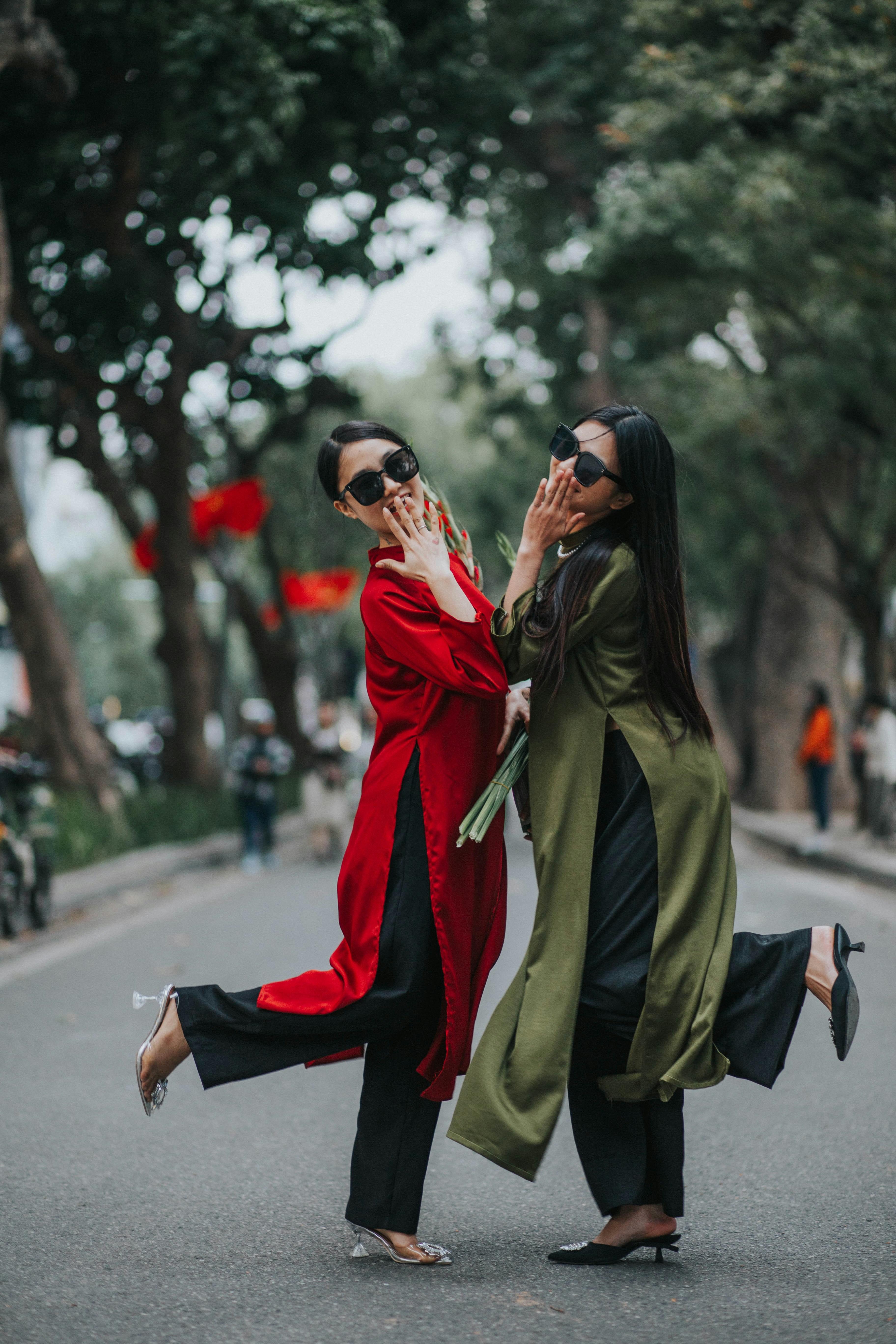 a couple of women standing next to each other on a street