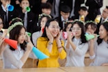 A cheerful group of kids wearing party hats and smiling.