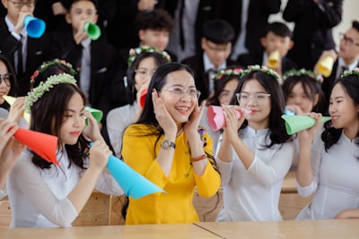 A cheerful group of kids wearing party hats and smiling.