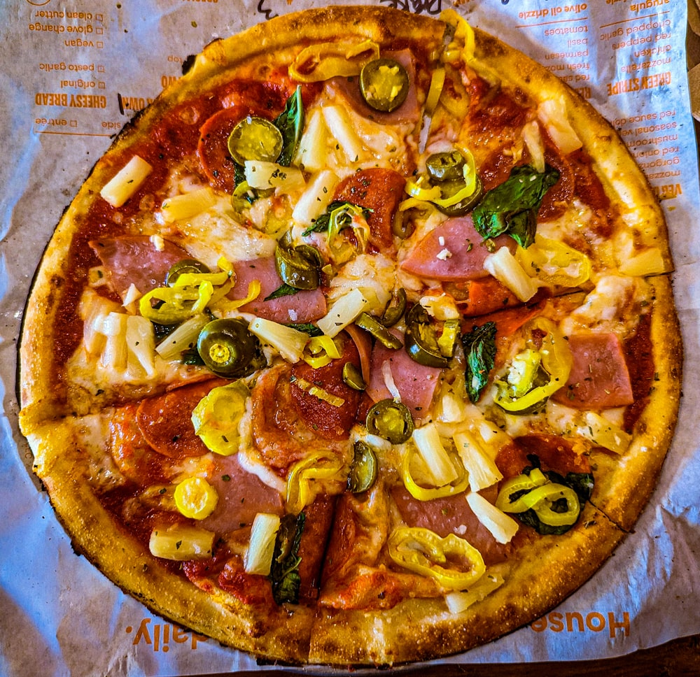 a pizza sitting on top of a piece of paper