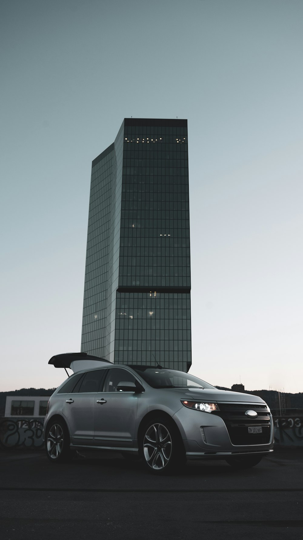 a car parked in front of a tall building