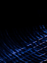 Abstract dark background with subtle golden and blue light streaks symbolizing technology and value.