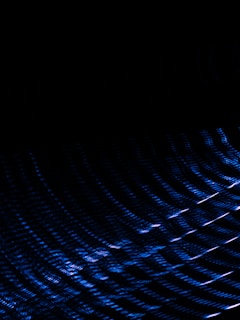 Dark background with an abstract pattern of blue light streaks creating a sense of motion and depth.