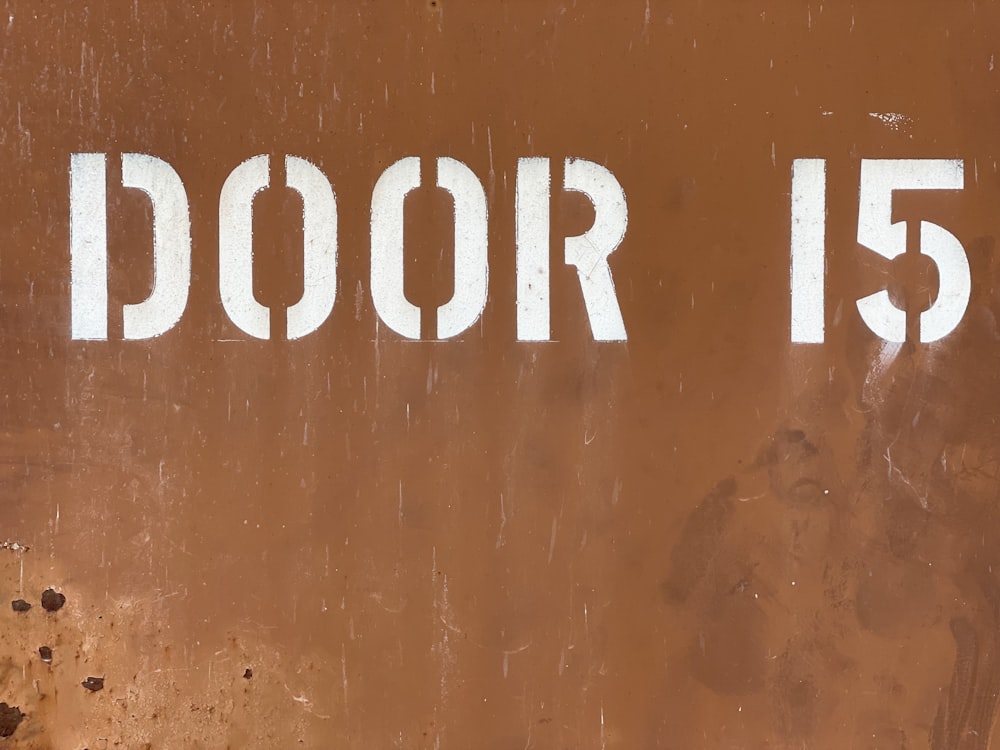 a close up of a door sign on a wall