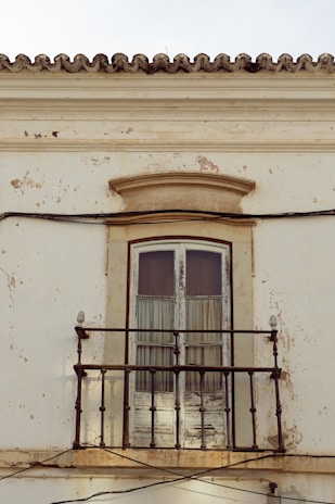 a balcony with a door and a window
