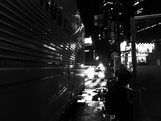 Night view of a Levo Log Transportes truck illuminated by streetlights on a city road