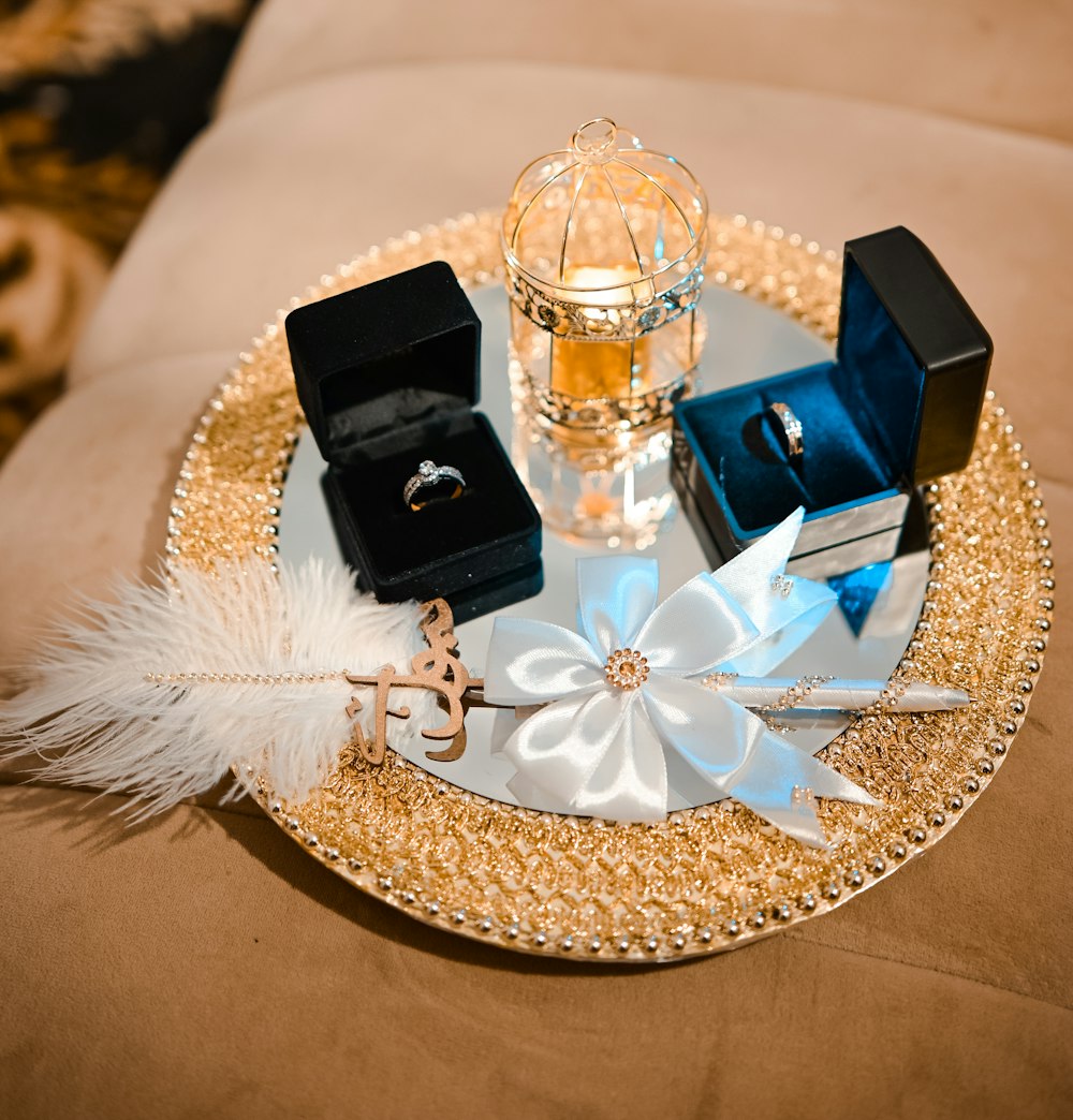 a gold plate topped with jewelry and a ring